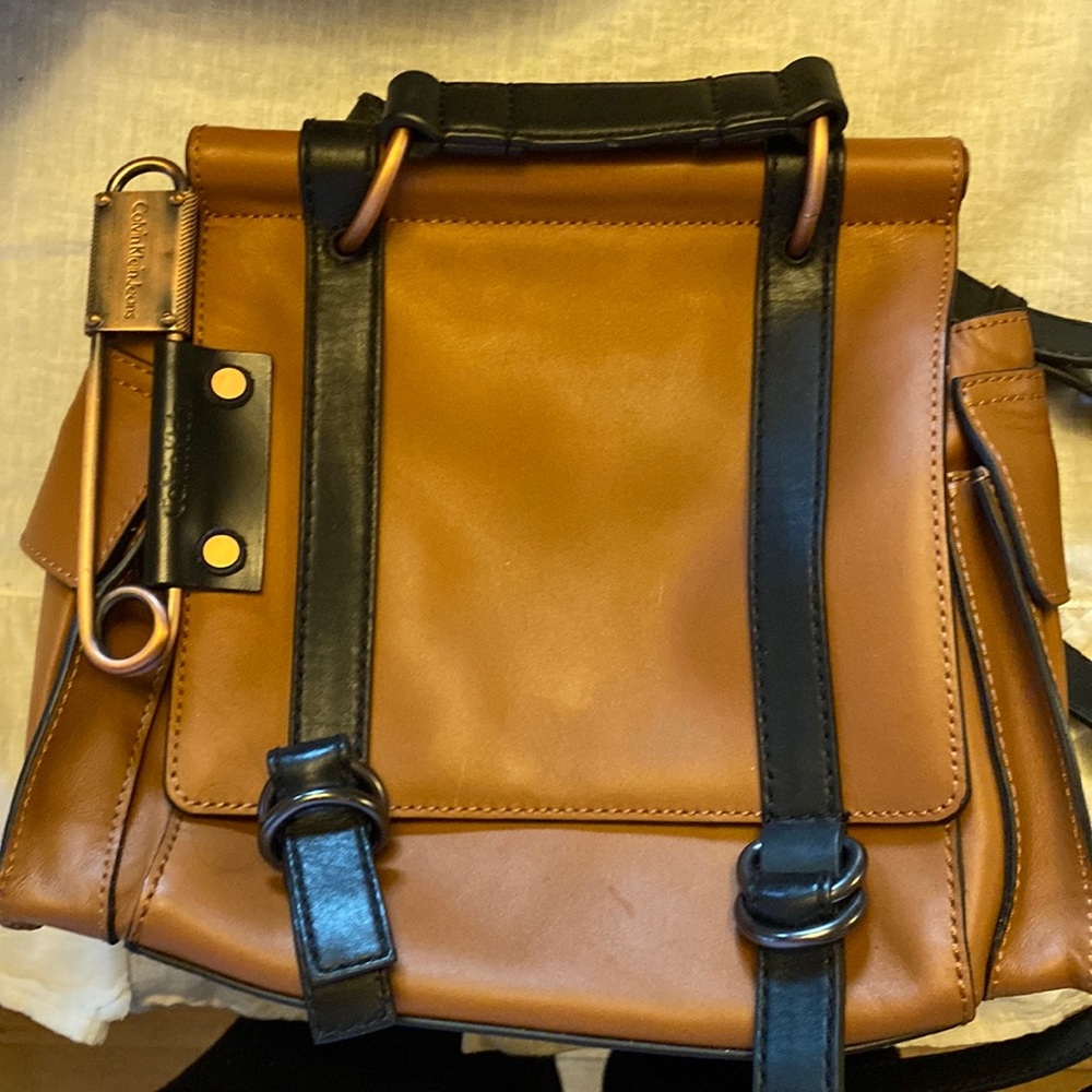 Calvin Klein tan leather purse with cool “safety pin” detail.